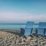 Retiring Abroad for Canadians - living the life on the beach with two blue chairs